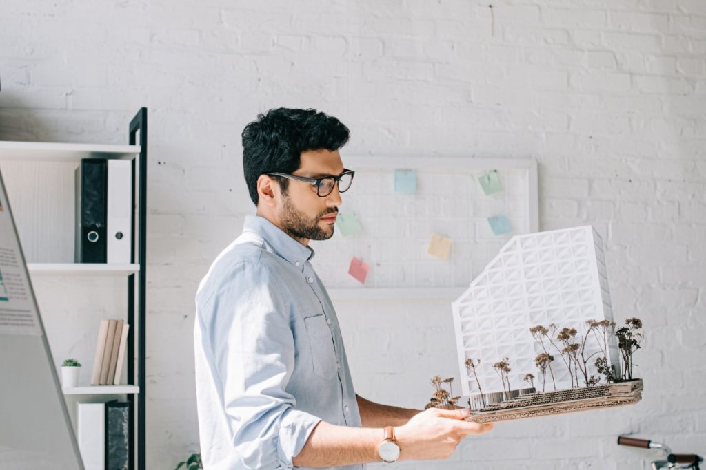 Architect Holding Building Model